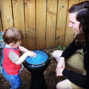 Teaching Clarkman that it's never too early to start playing drums! 